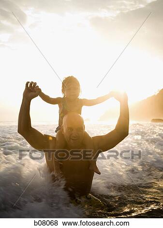 Father playing with young daughter on beach View Large Photo Image Stock Photo - Father playing with young daughter on beach. Fotosearch