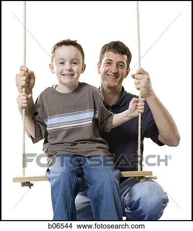 Father with son on swing View Large Photo Image Picture - Father with son on swing. Fotosearch