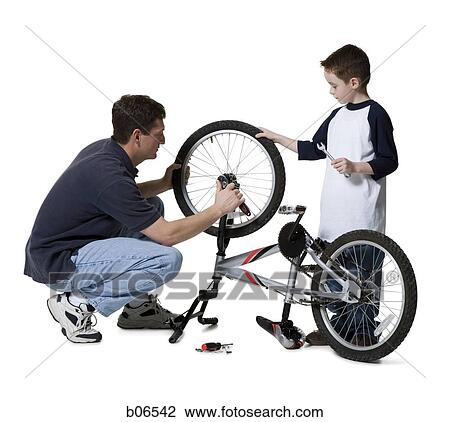 Father with son repairing bicycle View Large Photo Image Stock Image - Father with son repairing bicycle. Fotosearch
