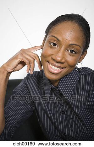 Stock Photo - Female African-American office worker smiling and posing. Fotosearch