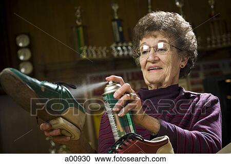 Female bowling attendant spraying bowling shoes View Large Photo Image Stock Image - Female bowling attendant spraying bowling shoes. Fotosearch
