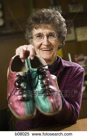 Female bowling attendant with bowling shoes View Large Photo Image Stock Photography - Female bowling attendant with bowling shoes. Fotosearch