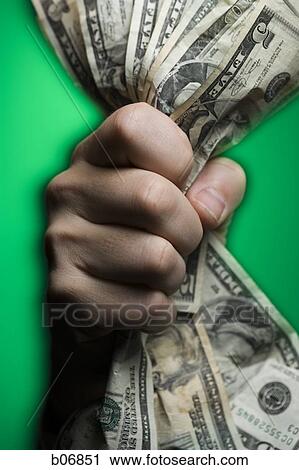 Fist extending handful of US banknotes View Large Photo Image Stock Image - Fist extending handful of US banknotes. Fotosearch
