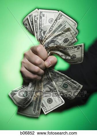 Fist extending handful of US banknotes View Large Photo Image Stock Image - Fist extending handful of US banknotes. Fotosearch