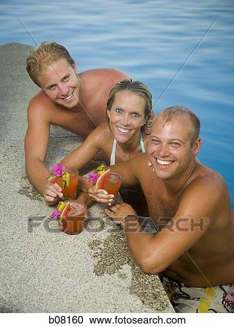 Friends relaxing in swimming pool View Large Photo Image Stock Image - Friends relaxing in swimming pool. Fotosearch