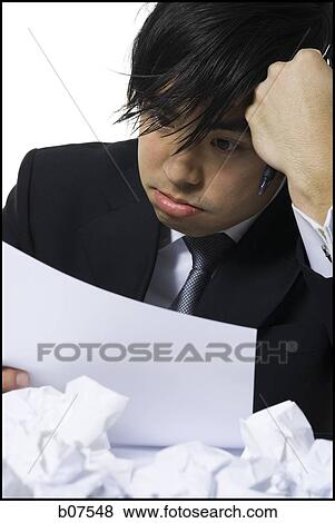 Frustrated businessman surrounded by crumpled papers View Large Photo Image Stock Photo - Frustrated businessman surrounded by crumpled papers. Fotosearch