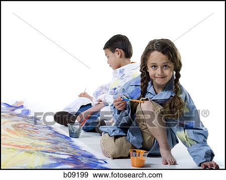 Stock Photo - Girl and her brother painting on the floor. Fotosearch