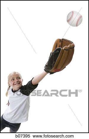 Girl catching a baseball in glove View Large Photo Image Stock Photography - Girl catching a baseball in glove. Fotosearch