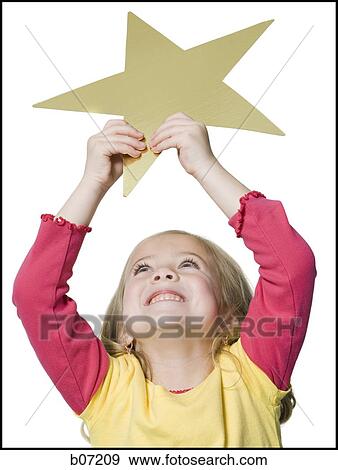 Girl holding up star View Large Photo Image Stock Photo - Girl holding up star. Fotosearch