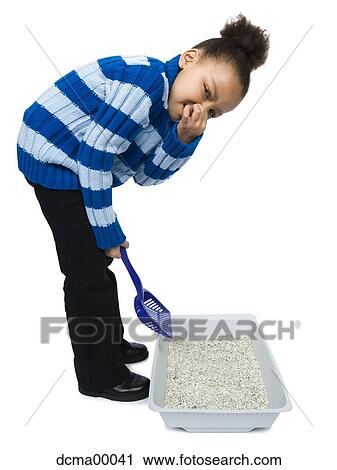Girl scooping kitty litter and holding nose View Large Photo Image Stock Image - Girl scooping kitty litter and holding nose. Fotosearch