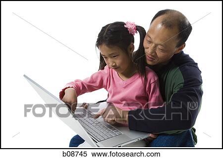 Girl sitting on her father's lap, using a laptop View Large Photo Image Stock Photography - Girl sitting on her father's lap, using a laptop. Fotosearch