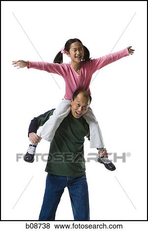 Stock Photo - Girl sitting on her father's shoulders. Fotosearch