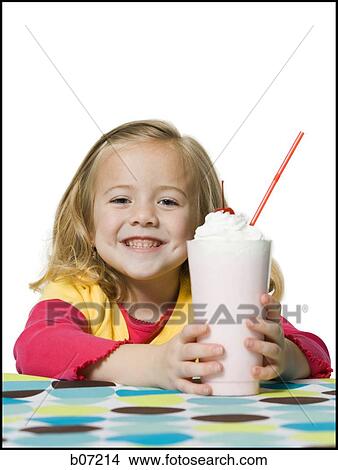 Picture - Girl smiling with milkshake. Fotosearch