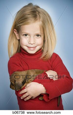 Girl smiling with puppy View Large Photo Image Stock Photo - Girl smiling with puppy. Fotosearch