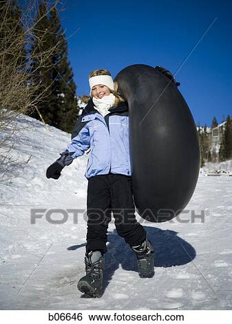 Girl walking with inner tube View Large Photo Image Stock Photograph - Girl walking with inner tube. Fotosearch