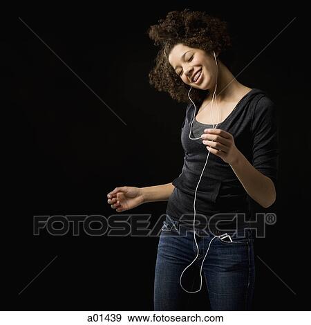 Girl with braces and MP3 player dancing and smiling View Large Photo Image Stock Photo - Girl with braces and MP3 player dancing and smiling. Fotosearch