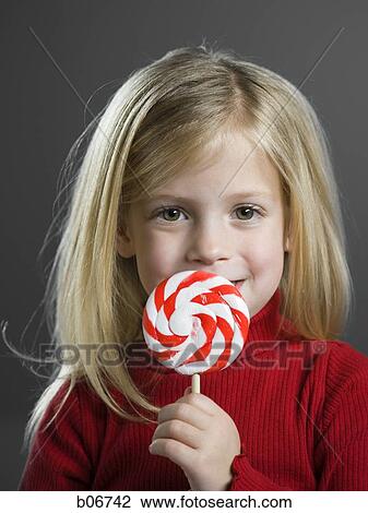 Stock Image - Girl with lollipop. Fotosearch