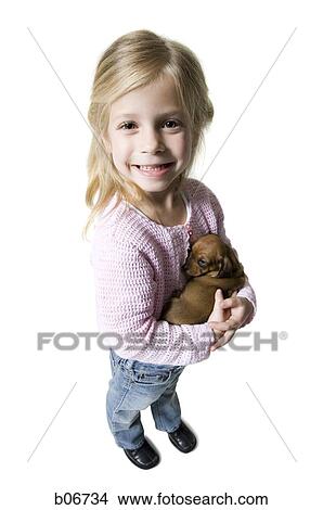 Girl with small puppy View Large Photo Image Picture - Girl with small puppy. Fotosearch