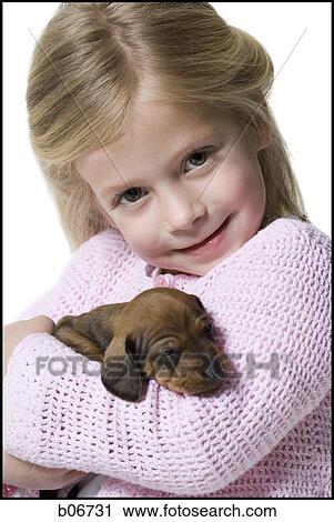 Girl with small puppy View Large Photo Image Stock Image - Girl with small puppy. Fotosearch