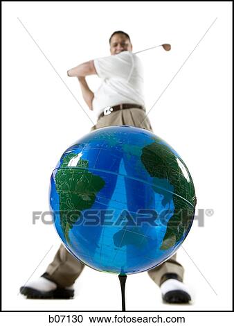 Golfer swinging at earth globe View Large Photo Image Stock Image - Golfer swinging at earth globe. Fotosearch