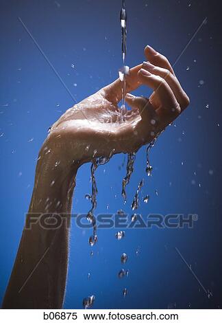Stock Photography - Hand catching falling stream of water. Fotosearch