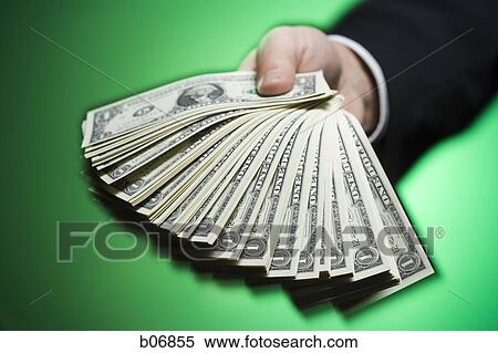 Hand extending fanned out US dollar bills View Large Photo Image Stock Photography - Hand extending fanned out US dollar bills. Fotosearch