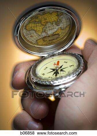 Hand holding compass View Large Photo Image Stock Photo - Hand holding compass. Fotosearch