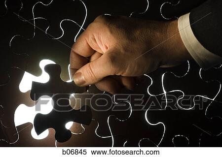 Hand inserting piece of jigsaw puzzle View Large Photo Image Stock Photography - Hand inserting piece of jigsaw puzzle. Fotosearch