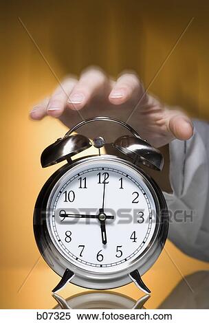 Hand reaching for alarm clock View Large Photo Image Stock Photography - Hand reaching for alarm clock. Fotosearch