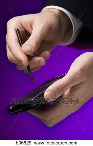 Hands operating palm computer View Large Photo Image Stock Photo - Hands operating palm computer. Fotosearch