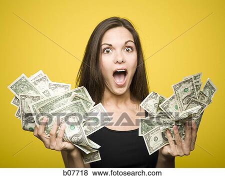 Happy woman holding US dollar bills View Large Photo Image Stock Photo - Happy woman holding US dollar bills. Fotosearch