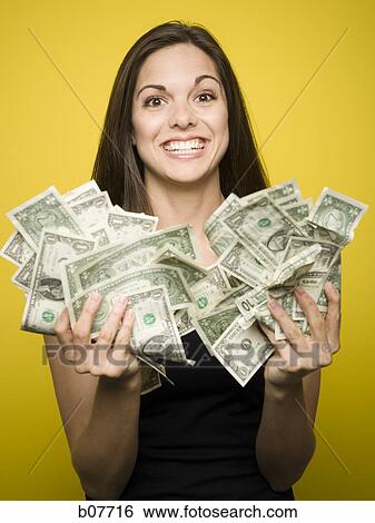 Happy woman holding US dollar bills View Large Photo Image Stock Photograph - Happy woman holding US dollar bills. Fotosearch