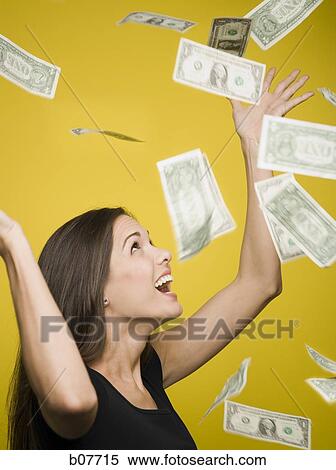 Happy woman tossing US dollar bills into the air View Large Photo Image Stock Photography - Happy woman tossing US dollar bills into the air. Fotosearch