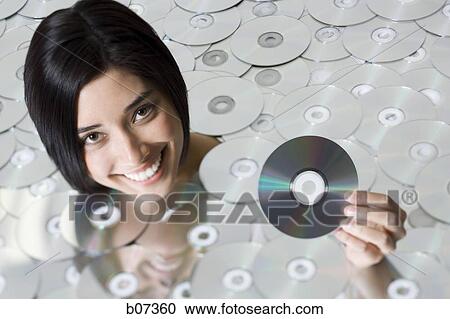 Head of woman emerging from CDs View Large Photo Image Stock Image - Head of woman emerging from CDs. Fotosearch