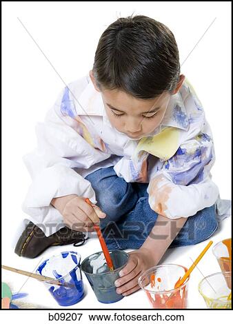 Stock Photo - High angle view of a boy holding a disposable cup. Fotosearch