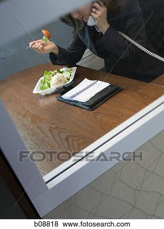 High angle view of a businesswoman talking on the telephone View Large Photo Image Stock Photo - High angle view of a businesswoman talking on the telephone. Fotosearch