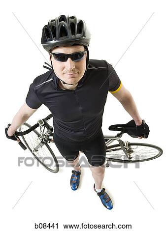 High angle view of a mature man with standing with a cycle View Large Photo Image Stock Image - High angle view of a mature man with standing with a cycle. Fotosearch