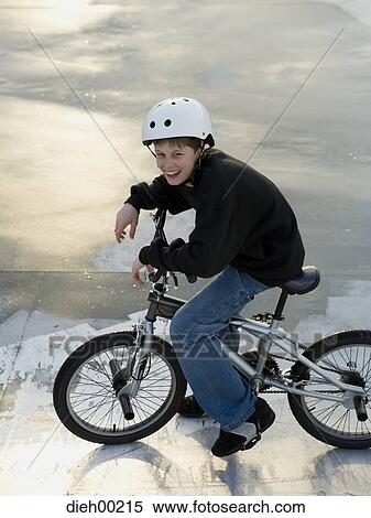 High angle view of a teenage boy cycling View Large Photo Image Stock Photography - High angle view of a teenage boy cycling. Fotosearch