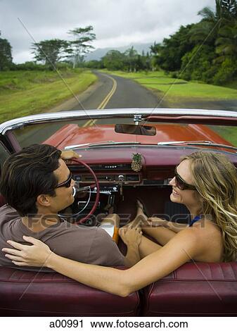 High angle view of a young couple sitting in the car View Large Photo Image Stock Image - High angle view of a young couple sitting in the car. Fotosearch