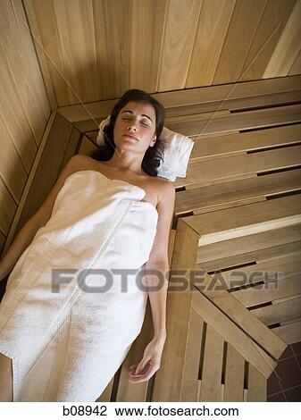 High angle view of a young woman lying down with her eyes closed View Large Photo Image Stock Image - High angle view of a young woman lying down with her eyes closed. Fotosearch