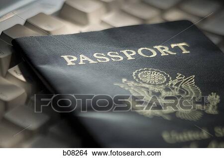 High angle view of an American passport on a computer keyboard View Large Photo Image Picture - High angle view of an American passport on a computer keyboard. Fotosearch