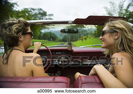 Stock Photography - High angle view of two young women in a car. Fotosearch