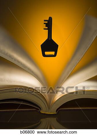 Key hovering above open book View Large Photo Image Stock Image - Key hovering above open book. Fotosearch