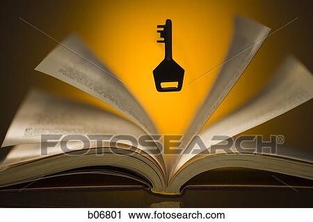 Key hovering above open book View Large Photo Image Stock Image - Key hovering above open book. Fotosearch