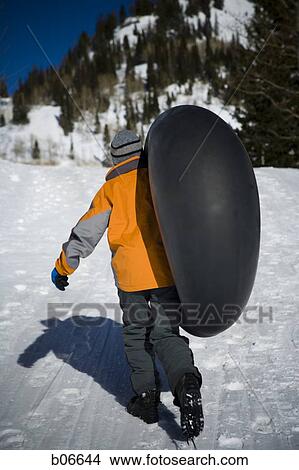 Kid walking with inner tube View Large Photo Image Picture - Kid walking with inner tube. Fotosearch