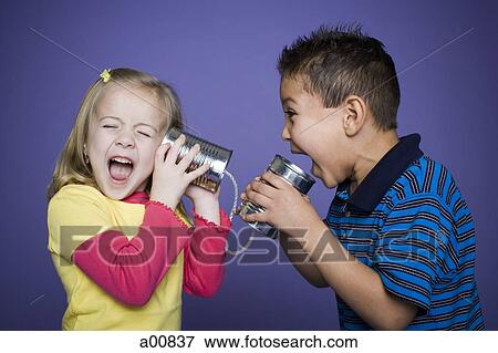 Stock Photo - Little boy and girl with tin cans and string. Fotosearch