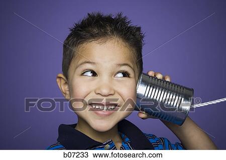 Little boy listening into tin can with string View Large Photo Image Stock Image - Little boy listening into tin can with string. Fotosearch