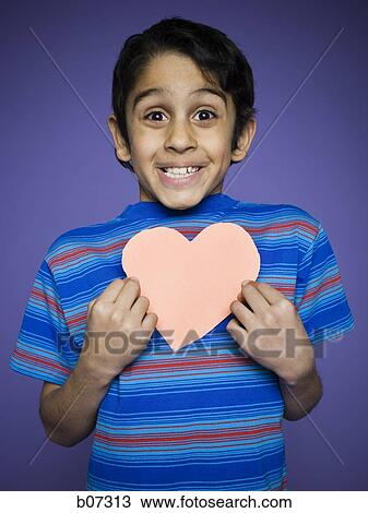 Little boy smiling with paper heart View Large Photo Image Stock Image - Little boy smiling with paper heart. Fotosearch
