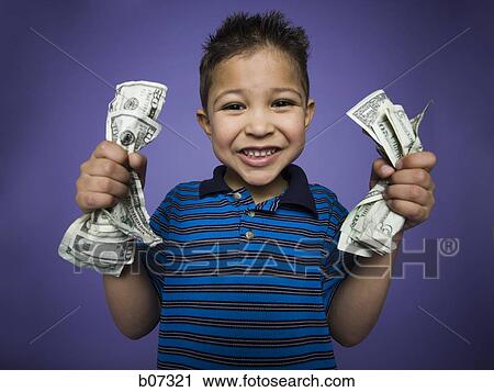 Little boy smiling with two bunches of banknotes View Large Photo Image Stock Image - Little boy smiling with two bunches of banknotes. Fotosearch