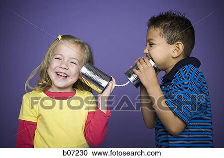 Little girl and boy with tin cans and string View Large Photo Image Stock Image - Little girl and boy with tin cans and string. Fotosearch